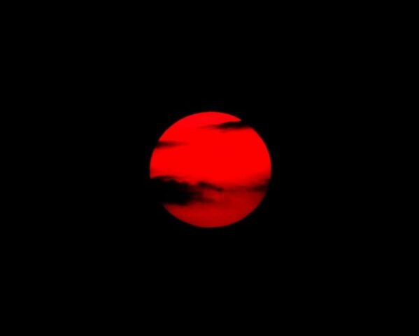 red moon on black background