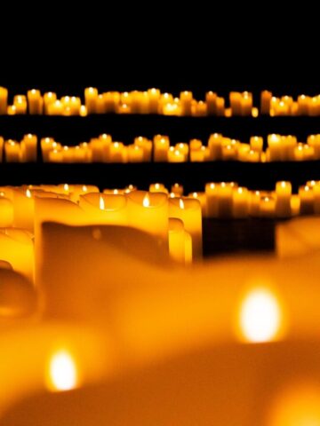 Photo by Cocodillaa.com Rows of glowing candles illuminate the darkness