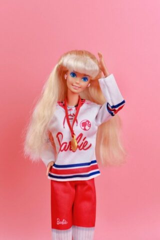 A barbie doll with blonde hair and blue eyes