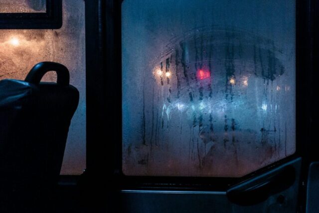 Photo by Cocodillaa.com a view of a street through a window at night