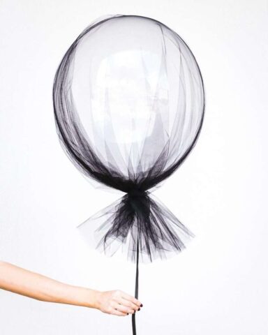 Photo by Cocodillaa.com person holding black balloon decal