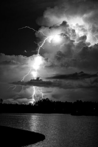 Photo by Cocodillaa.com grayscale photo of lightning over body of water