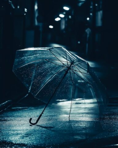 Photo by Cocodillaa.com a person holding an umbrella in the rain