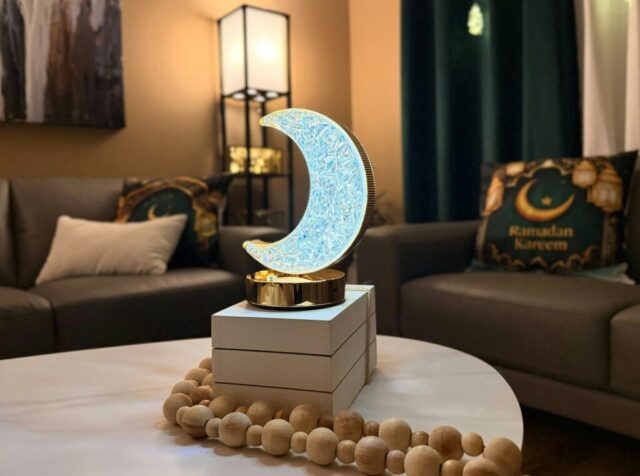 Photo by Cocodillaa.com Crescent moon decoration on table with sofas behind sofas