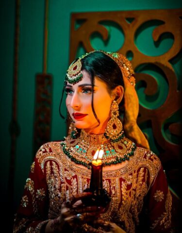 A woman in a costume holding a candle
