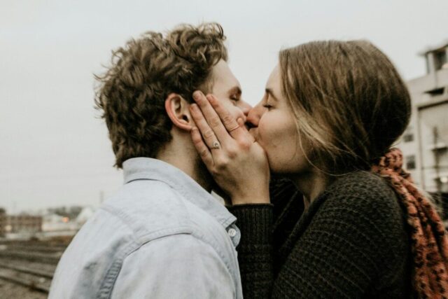 Photo by Cocodillaa.com couple kissing under gray clouds