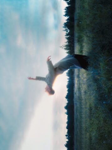 A person is flying through the air on a foggy day