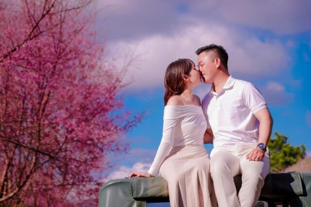 Photo by Cocodillaa.com couple, nature, wedding photoshoot, outdoors, vietnam, engagement photoshoot, dalat, peach blossoms, spring, kiss, love, kissing