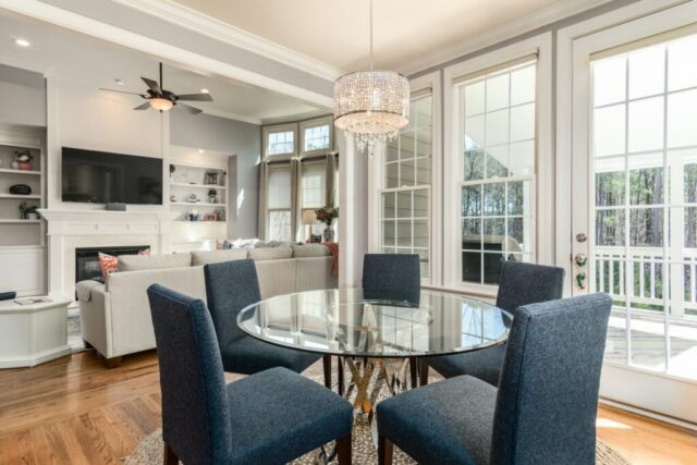 photo by Cocodillaa.com round clear glass-top table and five gray chairs dining se