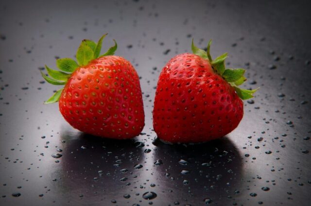 red strawberry on white surface