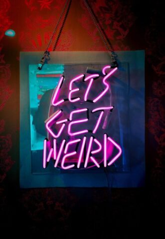 shallow focus photo of let's get weird neon light signage