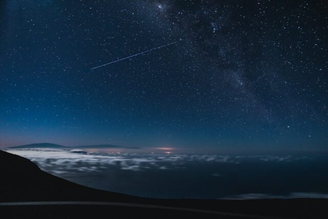 blue and black sky with stars and falling star at nighttime blue and black sky with stars and falling star at nighttime