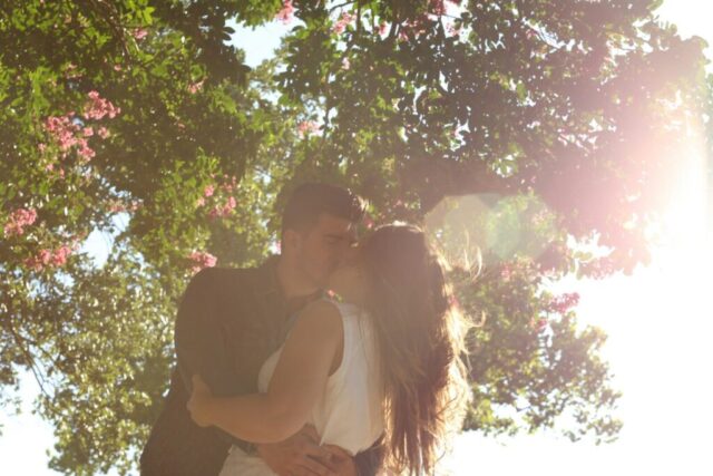 Photo by Cocodillaa.com man kissing woman under green tree during daytime