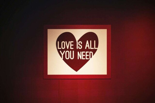 a picture of a heart on a wall with the words love is all you need