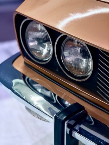 Close-up of a vintage car's headlights and bumper