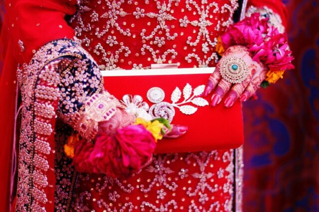 red and gold-colored floral wallet
