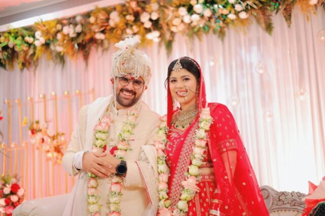 Newlyweds pose together at their wedding.