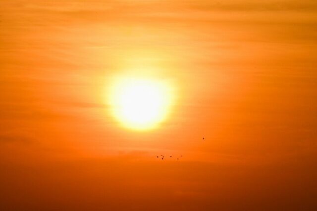 the sun is setting in the sky over the ocean