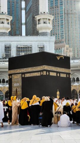 A group of people standing around a large black box