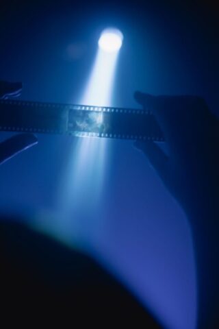 Photo by Cocodillaa.com a person holding a light saber