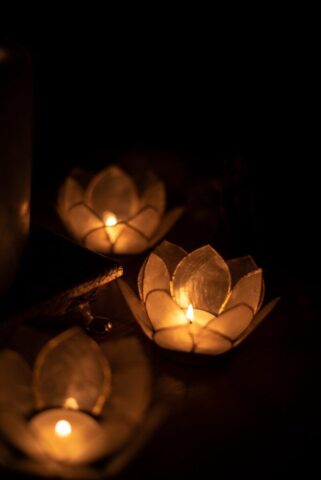 three lighted yellow tealights
