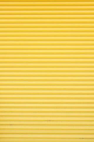 a yellow garage door that is closed