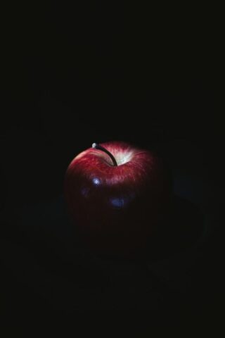 red apple on black surface