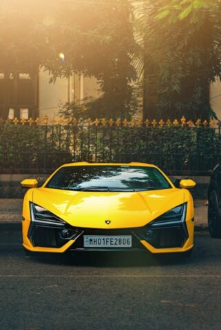 A bright yellow sports car parked on a street