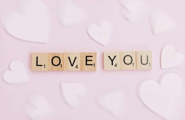 scrabbled wooden blocks spelling i love you