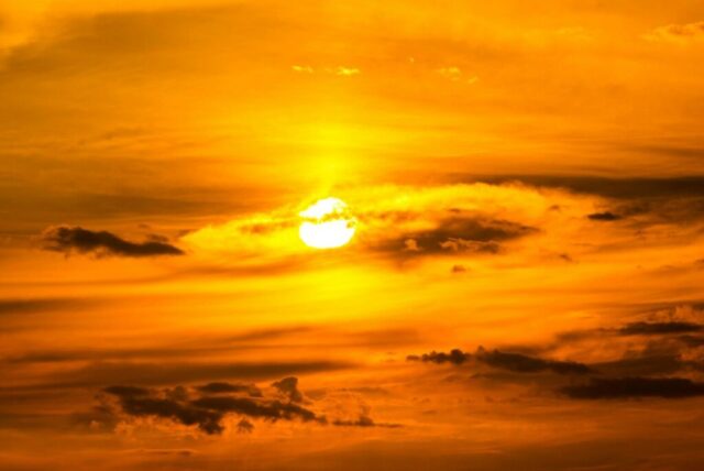 sun setting over the clouds