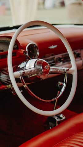 a steering wheel and dashboard of a classic car