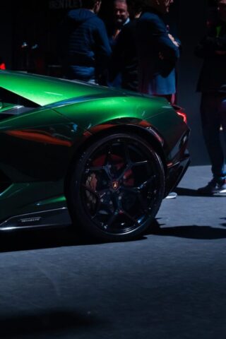 Green luxury sports car with black wheels