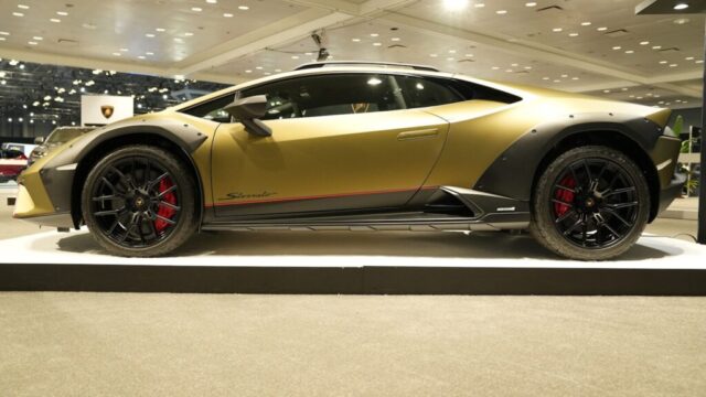 a yellow sports car on display in a showroom