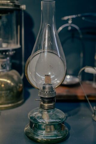 An old fashioned lamp is on a table