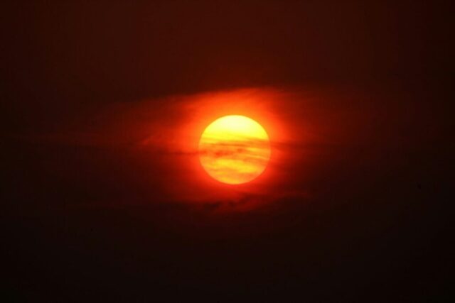 the sun is shining brightly in the dark sky