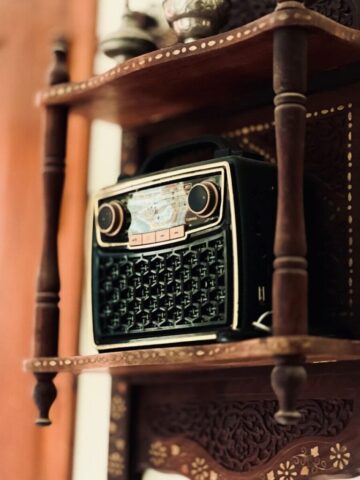A wooden shelf with a radio on top of it