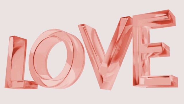 The word love is made up of shiny pink letters