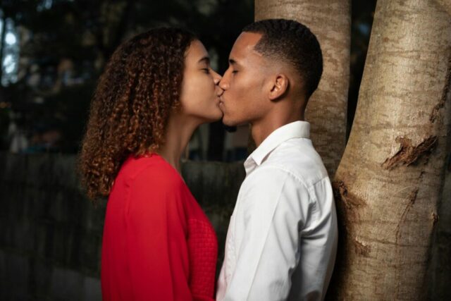 Photo by Cocodillaa.com man in white dress shirt kissing woman in red dress