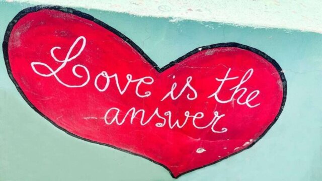 Love is the answer, written on a heart.