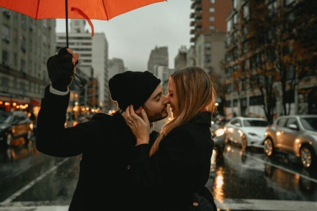 Photo by Cocodillaa.com woman in black jacket holding red umbrella during daytime