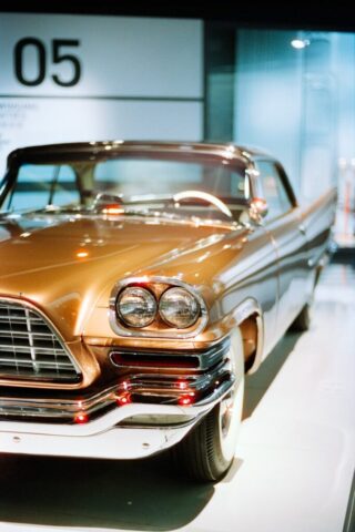 A vintage bronze car with chrome accents