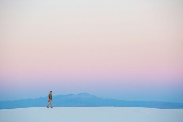human walking on snow covered mountain