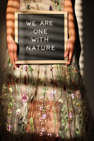 Photo by Cocodillaa.com a person holding a black sign