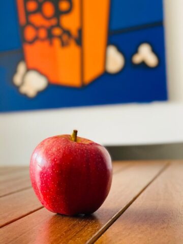 red apple fruit on brown wooden table