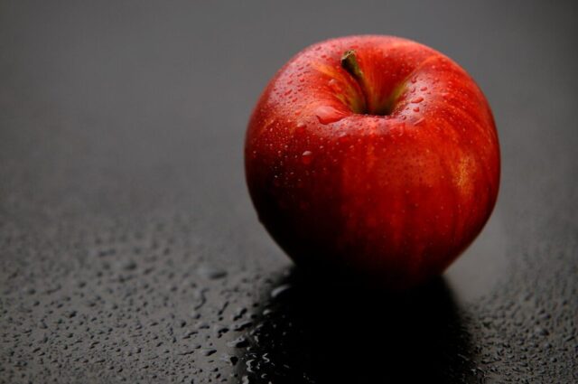 red apple fruit on black surface