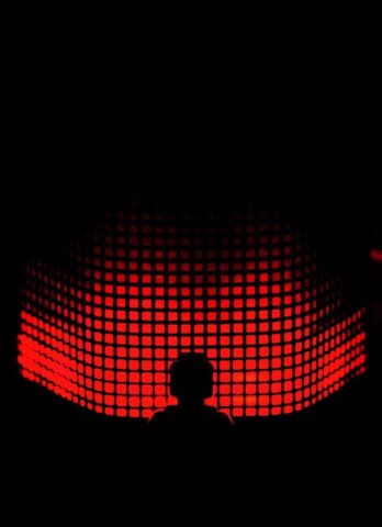 Photo by Cocodillaa.com a person standing in front of a red light