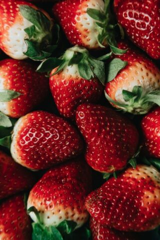 red strawberries on white ceramic plate