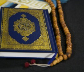 gold and black book on black and white textile