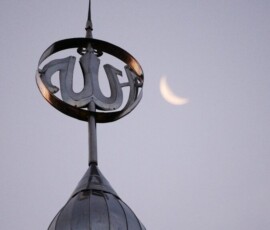 a clock on top of a building with the moon in the background