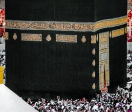 a large group of people standing around a large building